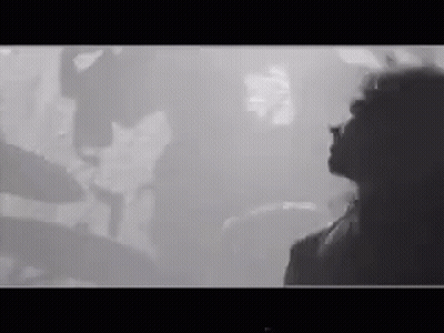 Black And White Photo Of Woman In Front Of Crowd GIF