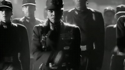 Black And White Photo Of Woman In Military Uniform With S On Hat GIF