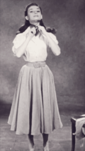 Black And White Photo Of Woman In White Shirt And Beige Skirt GIF