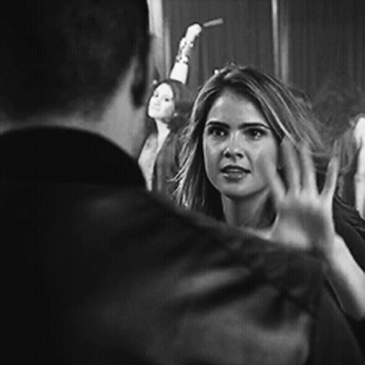 Black And White Photo Of Woman Waving At Man GIF
