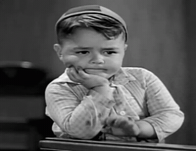 Black And White Photo Of Young Boy With Hand On Face GIF