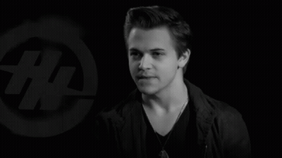 Black And White Photo Of Young Man In Front Of Logo Saying # GIF