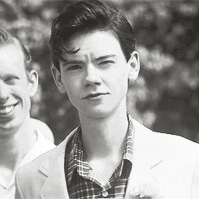 Black And White Photo Of Young Man In Suit Next To Another Man GIF