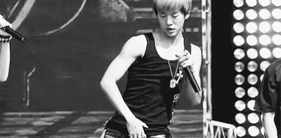 Black And White Photo Of Young Man Singing Into Microphone GIF