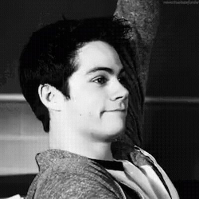 Black And White Photo Of Young Man Sitting On Chair GIF