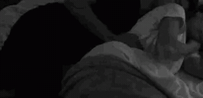 Black and White Photo Person Laying on Bed With Blanket on Head