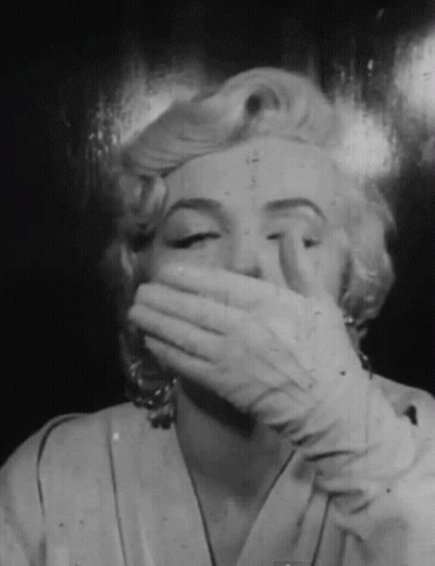 Black And White Photo Woman Covering Mouth GIF