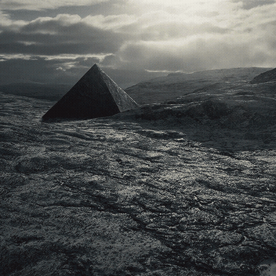 Black And White Pyramid In Rocky Field GIF