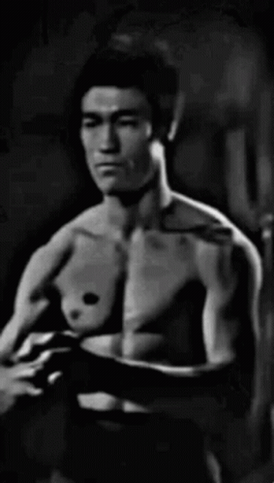 Black And White Shirtless Man In Dark Room GIF
