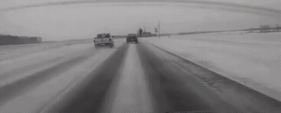 Black And White Snowy Highway With Cars GIF
