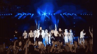 Black And White Stick Figures Standing Around Person GIF