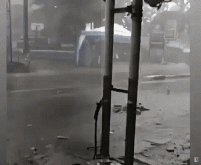 Black And White Street With Sign Saying A GIF