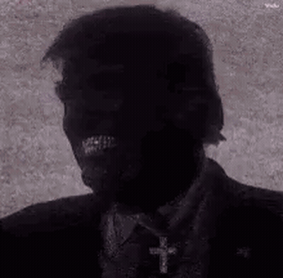 Black And White Suited Man With Cross Necklace GIF