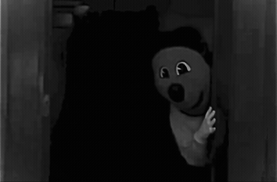 Black And White Teddy Bear In Dark Room GIF