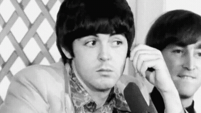 Black And White Two Men Sitting One Looking At Camera GIF