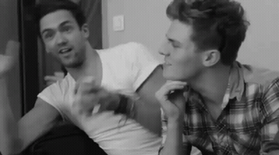 Black And White Two Men Talking On Couch GIF