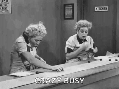 Black And White Two Women At Counter Saying Crazy Busy GIF