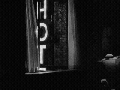 Black And White Window With Hotel Sign GIF