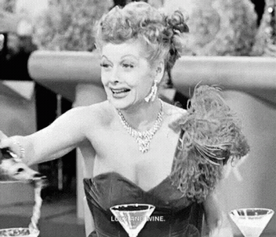 Black And White Woman At Table With Martini Glass GIF