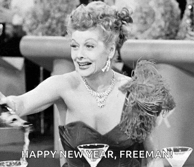 Black And White Woman At Table With Martini Glasses And Feather Boa GIF