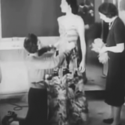 Black And White Woman Having Dress Adjusted GIF
