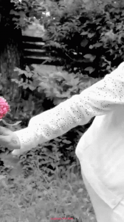 Black And White Woman Holding Pink Flower GIF