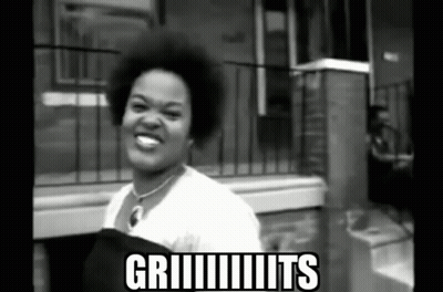 Black And White Woman In Front Of Griiiits Building GIF