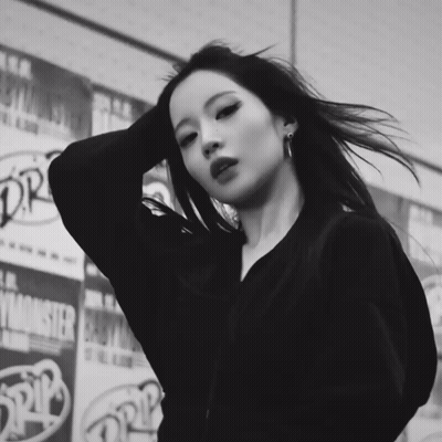Black And White Woman In Front Of Monster Advertisement GIF