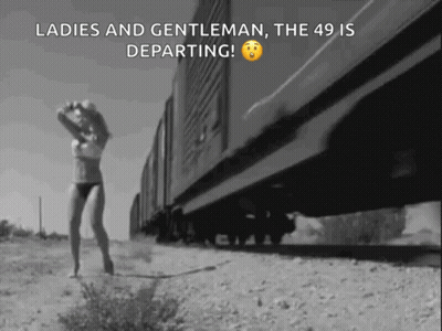 Black And White Woman In Lingerie Walking Beside Train GIF