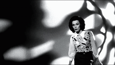 Black And White Woman In Patterned Shirt GIF