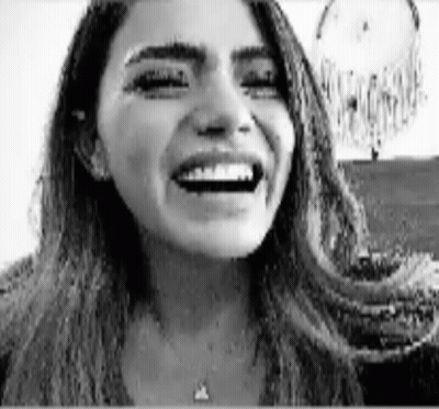 Black And White Woman Laughing By Dream Catcher GIF