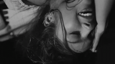 Black And White Woman Laying Upside Down Head In Air GIF