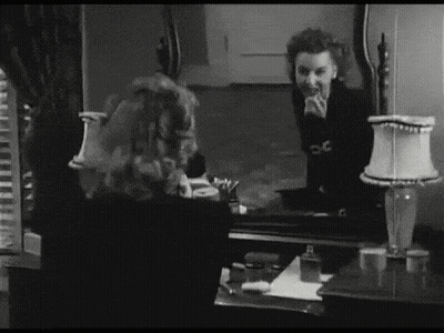 Black And White Woman Looking At Mirror Reflection GIF