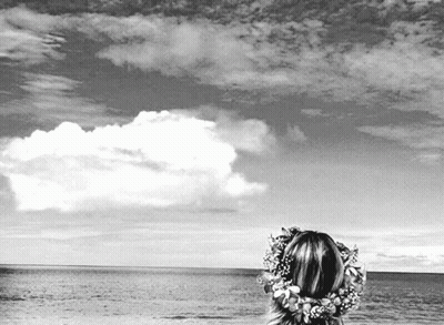 Black And White Woman Looking Over Ocean With Flower Crown GIF
