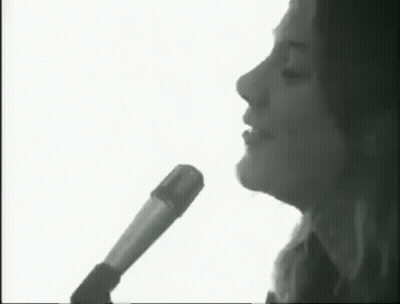 Black And White Woman Singing Into Microphone GIF