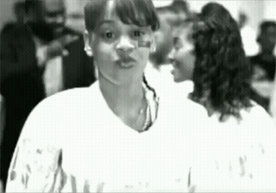Black And White Woman Standing In Crowd GIF