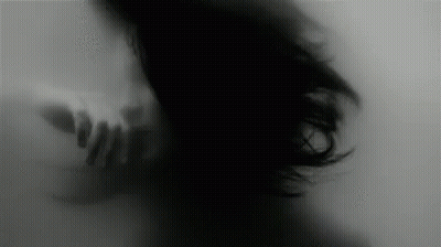 Black And White Woman With Hand Behind Her GIF