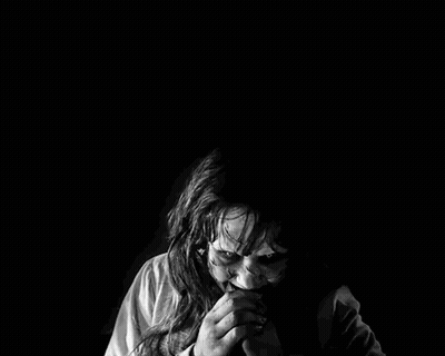 Black And White Woman With Scary Face In Dark GIF