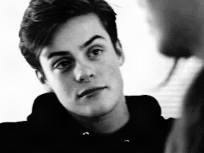 Black And White Young Man In Hoodie Looking At Camera GIF