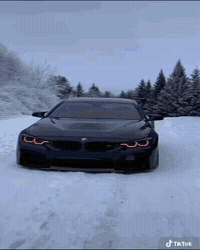 Black BMW Driving In Snow GIF