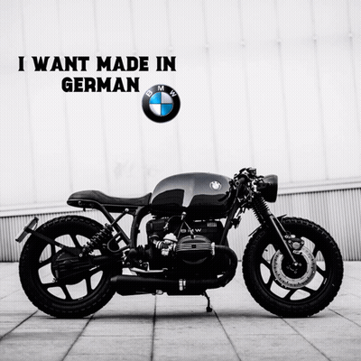 Black BMW Motorcycle In Front Of BMW Logo GIF