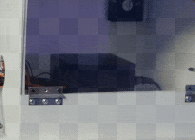 Black Box Behind Glass Door With Purple Light GIF