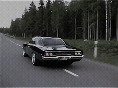 Black Car Driving Down Road With Trees GIF