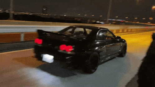 Black Car Driving On Highway At Night Red Lights GIF