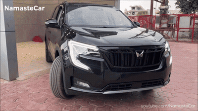 Black Car Parked In Front Of Namastecar Building GIF