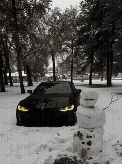 Black Car Parked In Snow With Snowman GIF