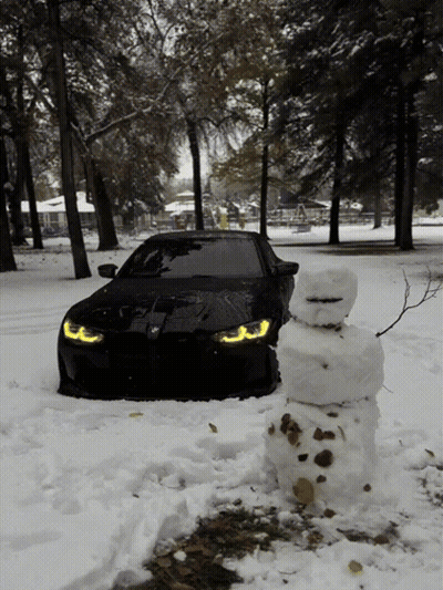 Black Car Parked Next to Snowman