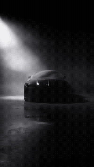 Black Car Silhouetted Against Spotlight In Dark GIF