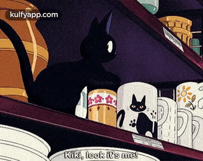 Black Cat On Shelf With Mugs Says Kiki Look It's Me GIF