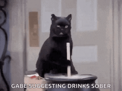 Black Cat Sitting On Cauldron With Candle GIF